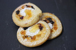 Cream cheese scrolls with orange and lemon zest, dried fruits